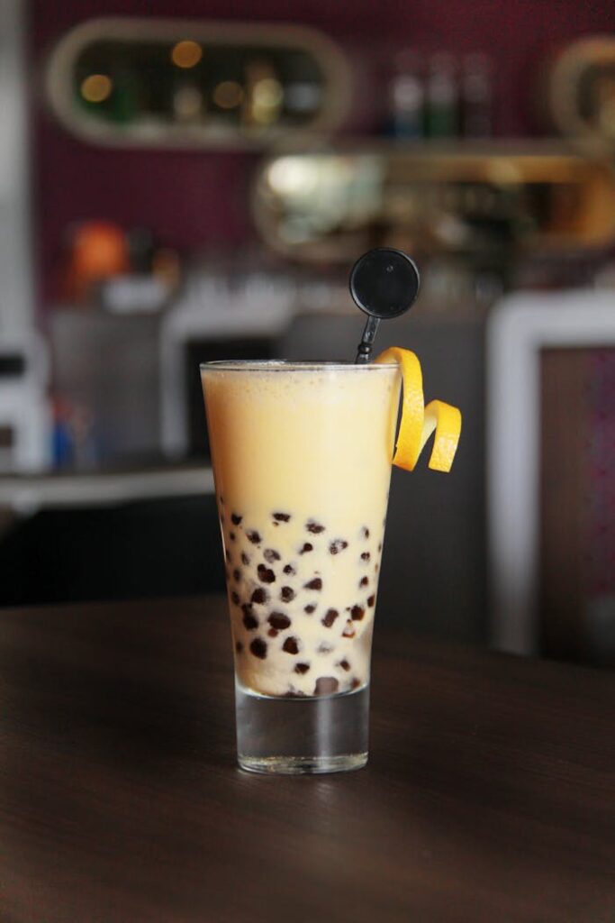 pexels-photo-4013151 A high glass of bubble tea with citrus garnish in a cozy café setting, perfect for a refreshing break.